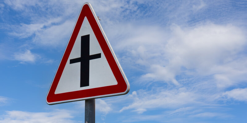UK triangular road sign with black crossroad marking and red outline