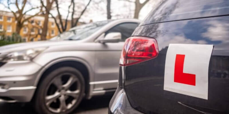 Learner 'L' plate stuck on back of a car