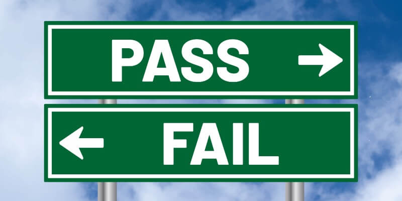 Sign with arrows pointing in opposite directions, with the words 'pass' and 'fail' displayed