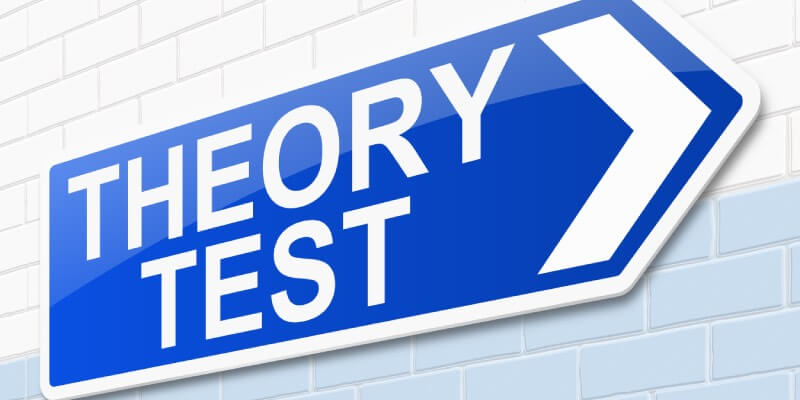 Blue arrow sign with 'theory test' written on it